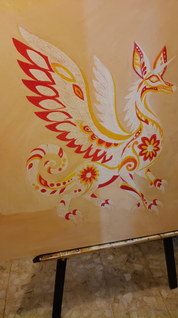 El dibujo sobre la tela imprimada: primero el rojo y el amarillo